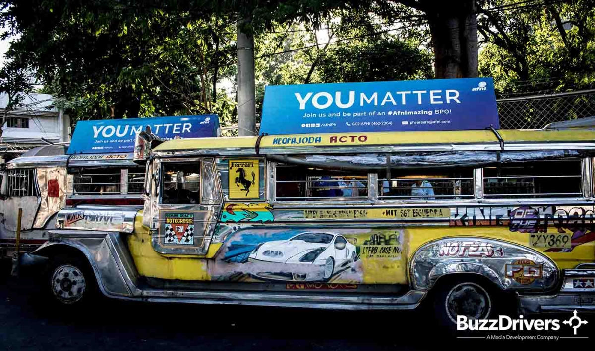 Jeepney with a roof advertising board in Quezon City.